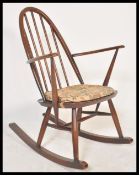 A vintage retro 20th Century Ercol spindle back rocking chair having a hooped back and a fitted seat