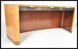 A 20th Century Art Deco solid maple wood desk having a bowed front with large open knee hole recess.