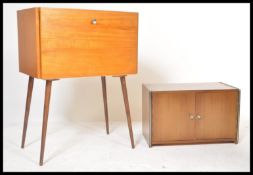 A retro 20th Century teak wood fall front vinyl record cabinet, the fall front opening to reveal