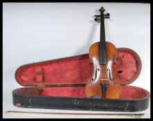 A vintage early 20th Century violin musical instrument having a single piece maple back with