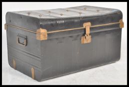 A vintage early 20th Century ebonised and gilt Japanned tin steamer trunk, hinged top with brass