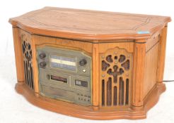 A Steepletone oak cased antique style hi-fi with inset record deck, CD, radio and tape deck.