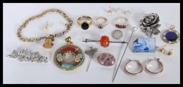 A group of vintage jewellery to include a onyx signet ring, yellow metal purple stone ring,