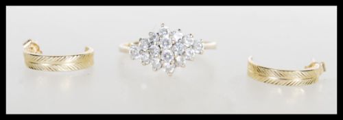 A hallmarked 9ct gold ladies cluster ring set with white brilliant cut stones to the head, (