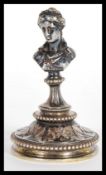 A 19th Century silver plated figural paperweight in the form of a lady or classical maiden raised on