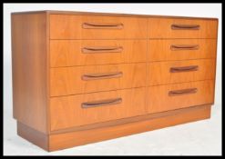 A 1970's G-Plan teak wood Kelso Pattern double chest of drawers being raised on an inset plinth with