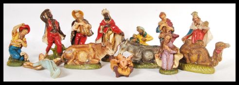 A vintage 20th Century composite Italian nativity set, consisting of Jesus in a crib, three wise