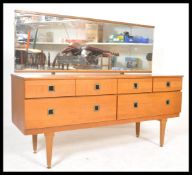 A vintage retro 20th Century teak wood dressing table having large rectangular mirror back in the