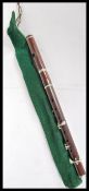 An Edwardian early 20th Century rosewood Flute, having nickel plated keys, kept within a green