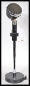 A vintage retro 20th Century Art Deco 1930's microphone in black bakelite mounted on a metal stand