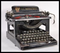 A vintage retro early 20th Century industrial desk top typewriter having large name plaque for LC