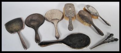 A collection of hallmarked silver vanity items to include various brushes, mirrors etc. along with a