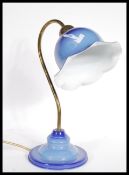A vintage retro 20th Century enamel table lamp raised on stepped circular base with flared epndant