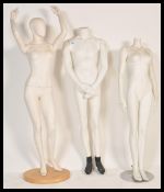 A collection of three 20th Century shop display female and male mannequins dummies, each with