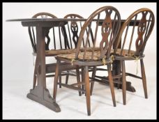 A retro mid 20th century Ercol refectory dining table and chairs being raised on angled tapering