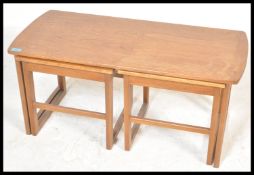 A retro 20th Century teak wood Danish inspired occasional coffee nest of tables consisting of long