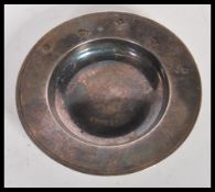 A silver hallmarked ' British Olympic Appeal ' trinket dish being engraved with the olympic logo.