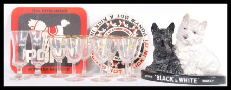 A vintage 20th Century point of sale advertising figure for Black and White Whisky together with a