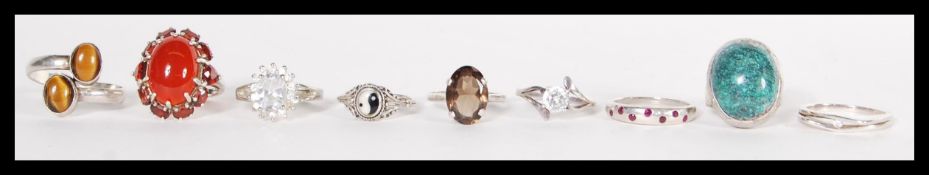 A group of ten sterling silver rings to include carnelian and garnet set ring, large brilliant cut
