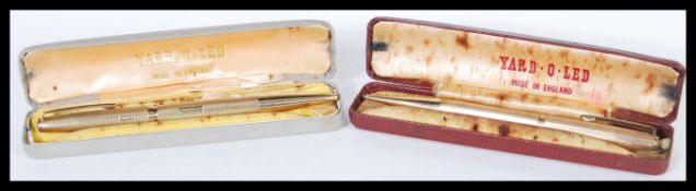 A hallmarked 9ct gold Yard-O-Led ball point pen having engine turned decoration complete in a fitted