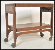 A vintage retro mid century  metamorphic two tier tea trolley. The top having swivel action to