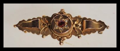 An early 20th Century Edwardian hallmarked 9ct gold bar brooch having a central faceted orange stone