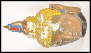 A large 20th Century Chinese plaster Buddha head having hand painted decoration. The skin having a