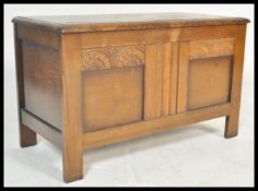 An early 20th Century 1930's oak blanket box chest having a  hinged lid to the top over panelled