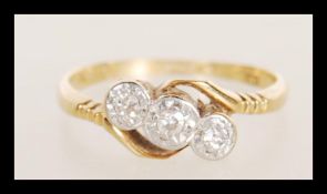 A stamped 18ct gold platinum ring illusion set with three brilliant cut diamonds. Weight 1.8g.