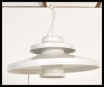 A vintage retro light fixture in the manner of Poul Henningsen having a two step UFO type shape in a