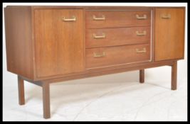 A vintage retro teak mid 20th Century sideboard, cupboard either side and a bank of 3 central