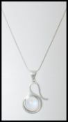 A stamped 925 silver necklace having a silver pendant set with a large moonstone cabochon. Weight