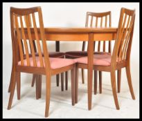 A vintage retro 20th Century G-Plan dining suite consisting of a G-Plan extending circular dining