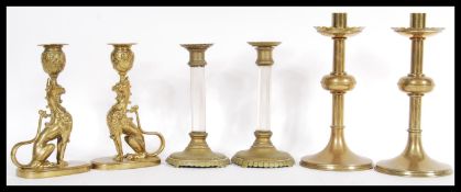 Three pairs of brass candlesticks dating from the 19th Century to include a pair with glass column