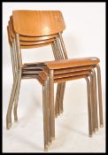A set of four vintage mid 20th century church / village hall stacking chairs. With tubular frames