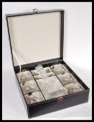 A 20th Century cased cut glass decanter and six matching tumblers. All contained within original