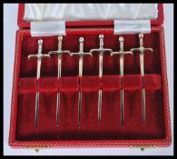 A cased set of six 20th Century hallmarked silver sandwich markers or skewers in the form of