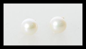 A pair of fresh water pearl earrings having 9ct gold posts. Weight 0.9g. Stamped 375.
