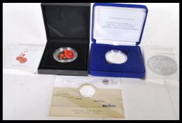 A group of three silver proof coins to include a 999 silver outbreak £20 coin, a ' For The