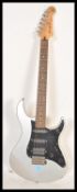 A vintage Yamaha Pacifica PAC112X stratocaster style electric six string guitar. Silver, with