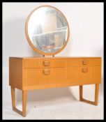 A retro 20th Century Danish inspired teak wood dressing table chest, central circular mirror over