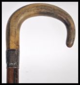 A 19th Century Victorian hallmarked silver collared walking stick cane with shaped horn handle.
