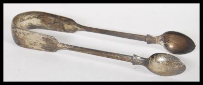 A pair of Georgian silver hallmarked sugar tongs of simple form. Hallmarked London 1834. Weight 25.