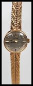 A vintage boxed Omega 9ct gold ladies watch set to a 9ct gold herringbone watch bracelet strap.