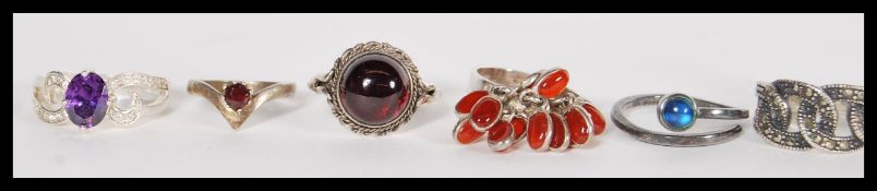 A group of ten sterling silver rings to include blue moonstone crossover ring, amethyst and white