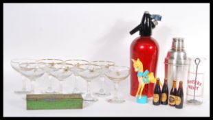 A fabulous collection vintage 20th Century advertising items to include a set of eight Babycham