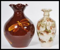 A 20th century vintage Somerset pottery slip vase having a marbled glaze and fanned rim, signed