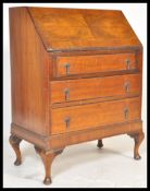 An early 20th Century Edwardian walnut veneer writing office bureau desk having a fall front with