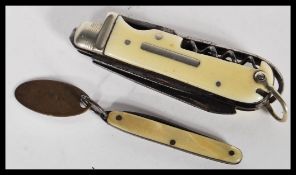 A 20th century vintage pen knife with a bone casing, having a corkscrew and two blades, with a