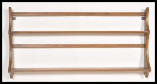 A 20th Century two tier Ercol blonde Delft plate rack with hanging brackets attached. Measures 50 cm